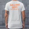 white and orange gallery dept shirt